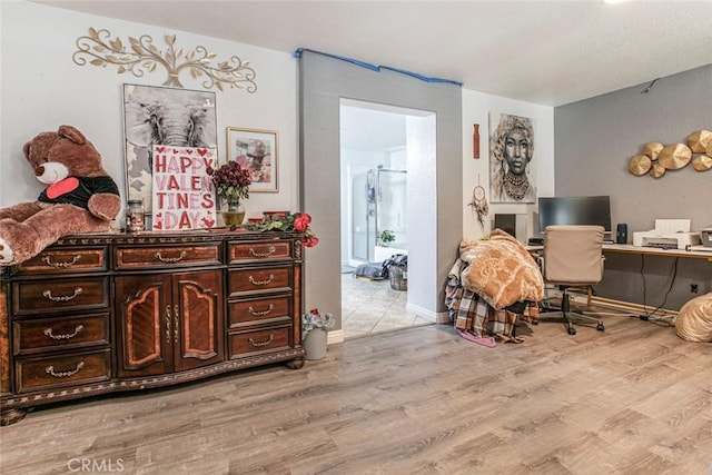 office area featuring light wood-style floors and baseboards