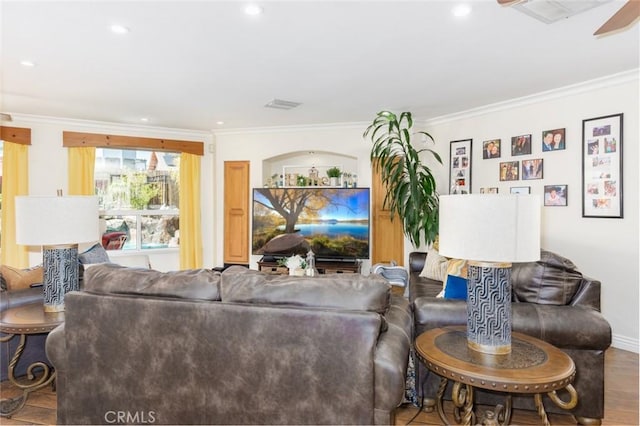 living room featuring visible vents, ornamental molding, wood finished floors, and recessed lighting