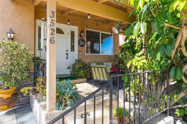 view of exterior entry featuring stucco siding