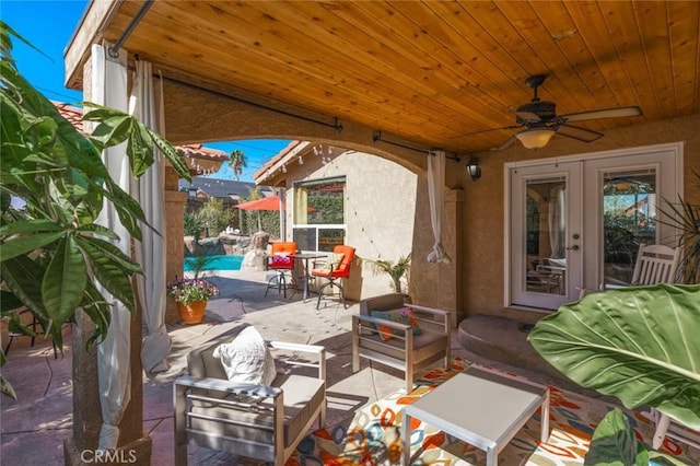 view of patio / terrace with french doors, an outdoor pool, and ceiling fan