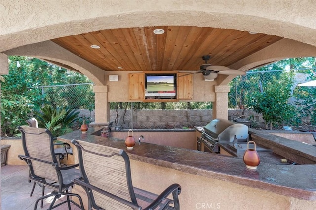 view of patio / terrace with exterior kitchen, ceiling fan, and area for grilling