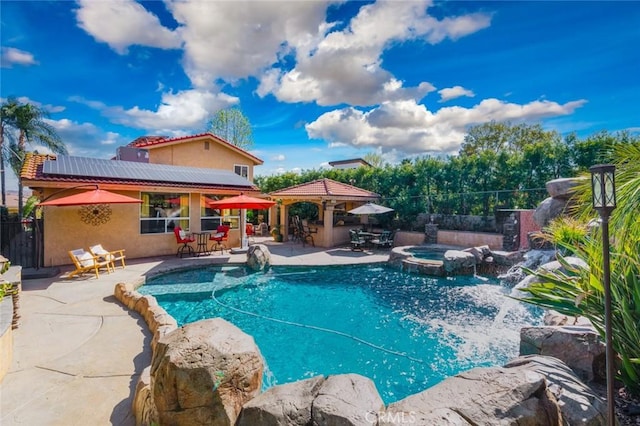 view of pool featuring a gazebo, fence, a bar, and a patio