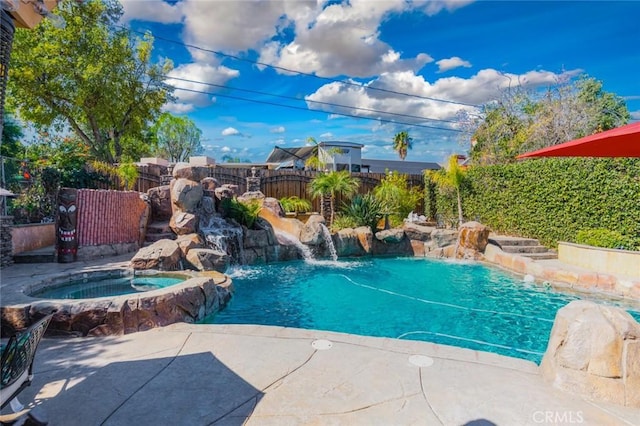 view of pool featuring an in ground hot tub, a fenced backyard, and a fenced in pool