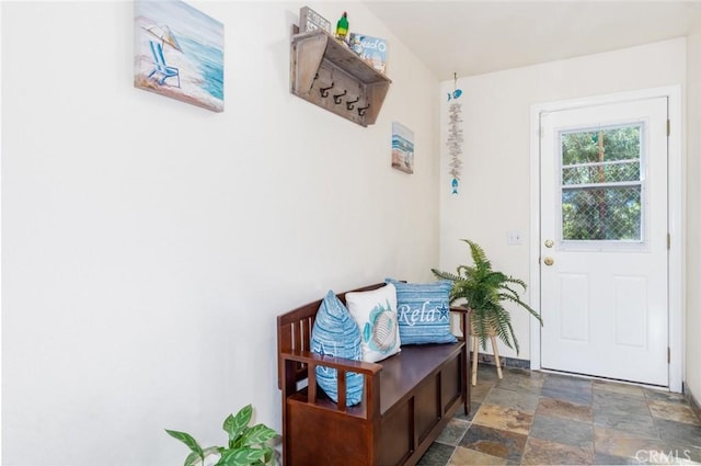 doorway featuring stone finish floor