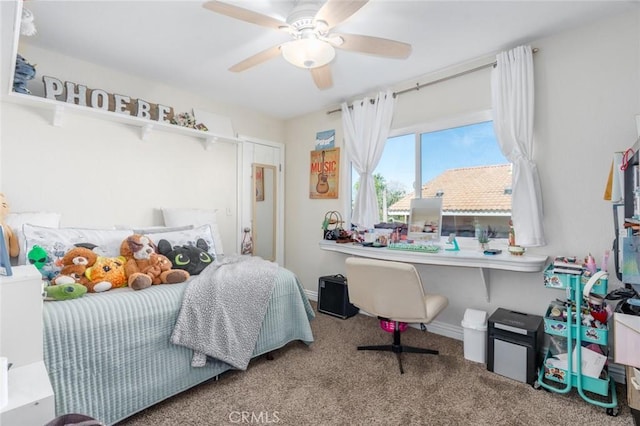 carpeted bedroom with a ceiling fan and baseboards