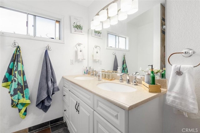 full bathroom featuring a sink and double vanity