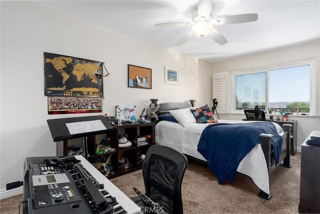 carpeted bedroom with a ceiling fan and baseboards