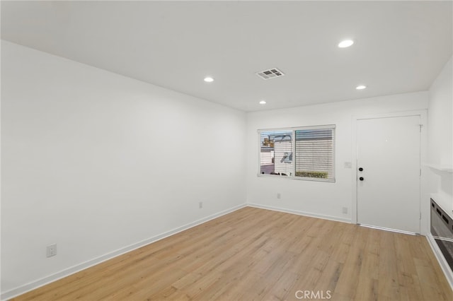 unfurnished room featuring light wood finished floors, baseboards, visible vents, and recessed lighting