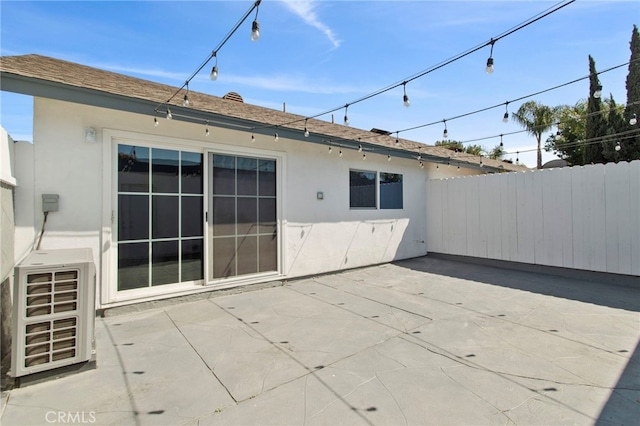 back of house featuring a patio area, fence, ac unit, and stucco siding