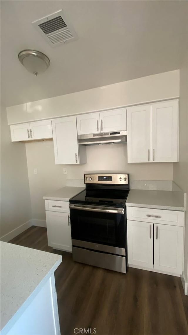 kitchen with visible vents, stainless steel electric range oven, dark wood-style flooring, under cabinet range hood, and white cabinetry