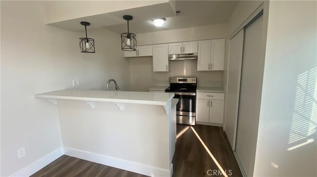 kitchen with under cabinet range hood, white cabinetry, light countertops, stainless steel electric range, and decorative light fixtures