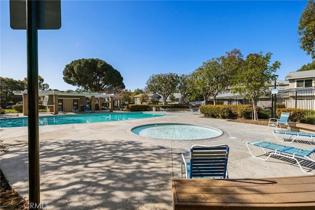 pool featuring a community hot tub, fence, and a patio