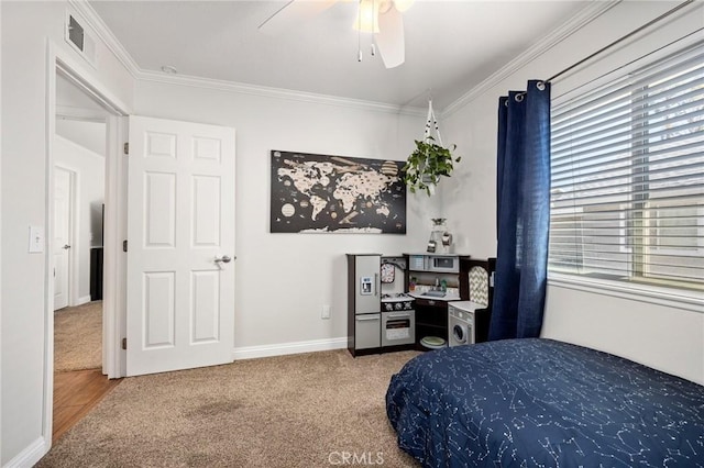 carpeted bedroom with baseboards, a ceiling fan, visible vents, and crown molding