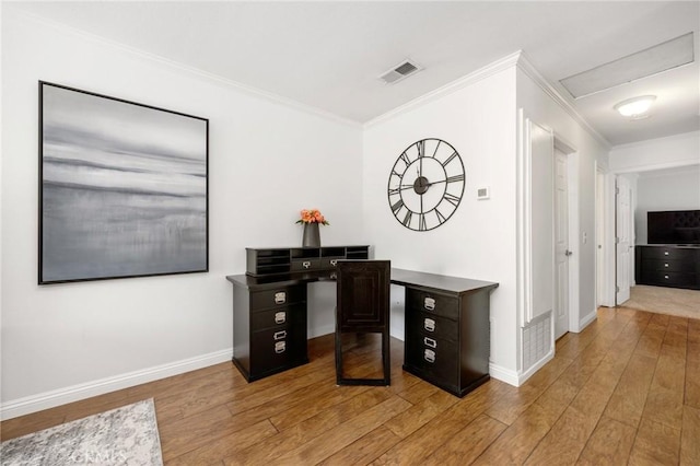 office featuring light wood finished floors, baseboards, visible vents, and crown molding