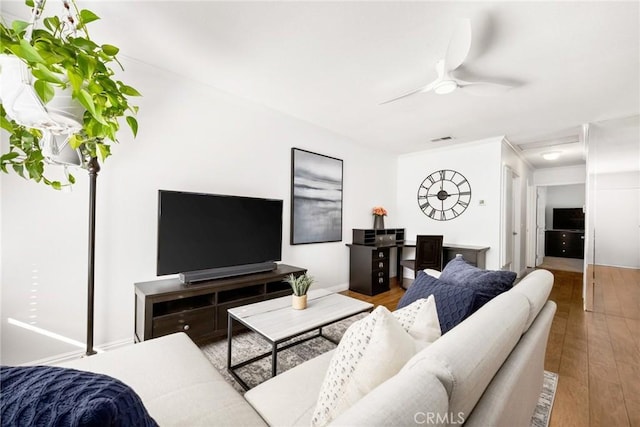 living room featuring ceiling fan, wood finished floors, and visible vents