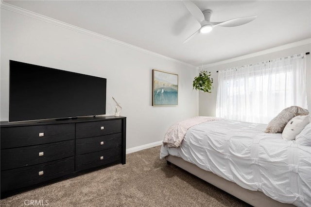 carpeted bedroom with baseboards, ornamental molding, and ceiling fan