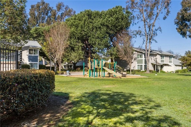 community jungle gym featuring a lawn