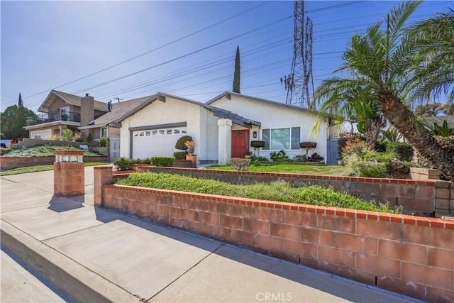 single story home featuring an attached garage, driveway, and stucco siding