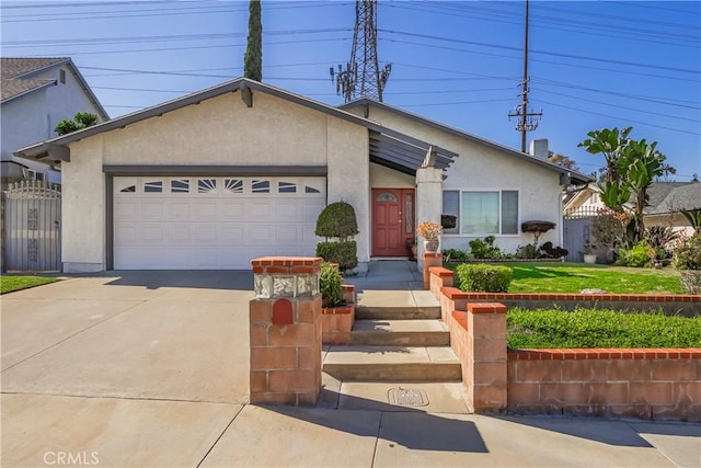 view of front of property with a garage, driveway, fence, and stucco siding