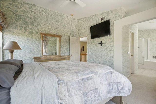 carpeted bedroom featuring wallpapered walls, ceiling fan, visible vents, and ensuite bathroom