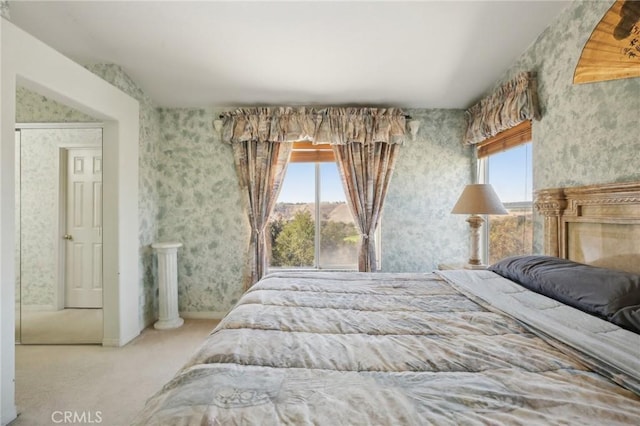 bedroom with wallpapered walls and baseboards