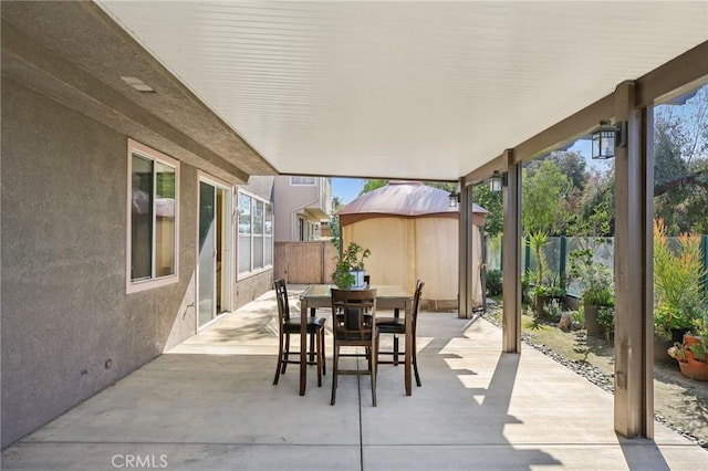 view of patio with outdoor dining area and a fenced backyard