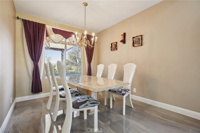 dining space featuring baseboards and a notable chandelier