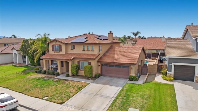 view of front of house with stucco siding, a front lawn, concrete driveway, a garage, and solar panels