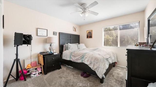 carpeted bedroom with baseboards and a ceiling fan