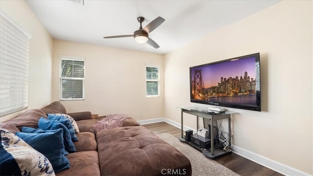 living area featuring plenty of natural light, baseboards, and wood finished floors