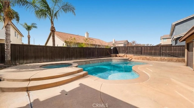 view of swimming pool with a patio, a fenced backyard, and a pool with connected hot tub