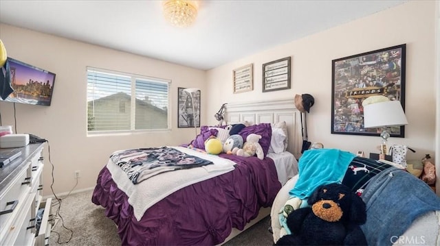 bedroom featuring baseboards and carpet flooring