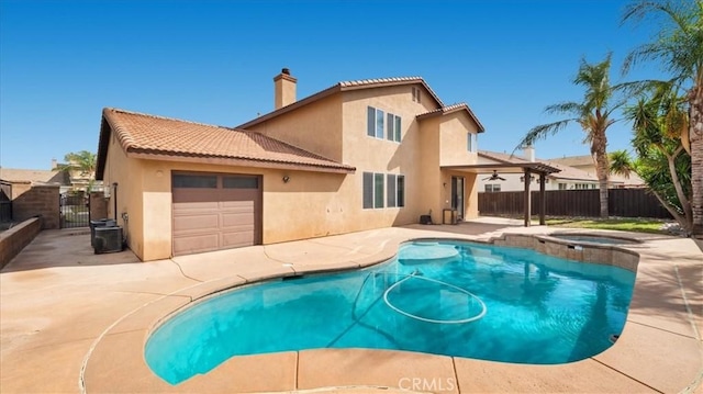 rear view of property featuring a gate, stucco siding, a chimney, and fence