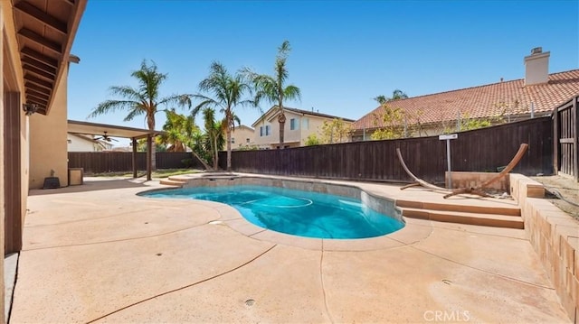 view of pool featuring a patio, a fenced backyard, and a fenced in pool