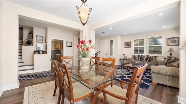 dining space with recessed lighting, baseboards, dark wood-style floors, and stairs