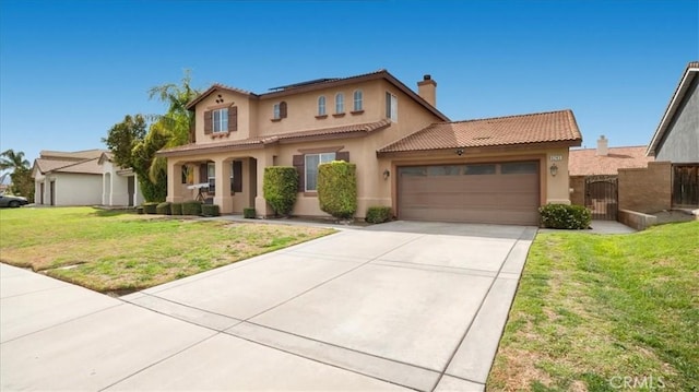 mediterranean / spanish-style house featuring stucco siding, an attached garage, a front yard, and a gate