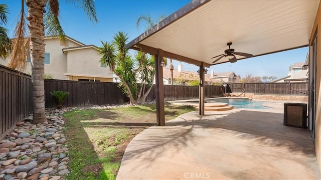 view of patio with a fenced backyard, a fenced in pool, and ceiling fan