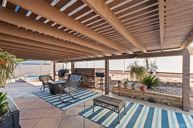 view of patio / terrace featuring an in ground hot tub, outdoor dining area, and a fenced backyard