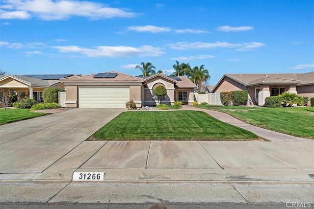 single story home with a front yard, solar panels, driveway, and stucco siding