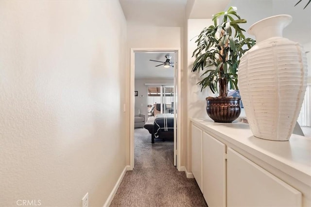 corridor with carpet floors and baseboards