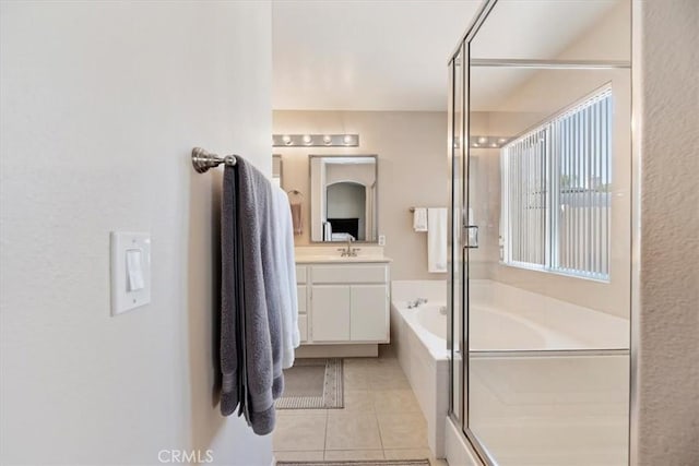 full bath with a bath, tile patterned flooring, vanity, and a shower stall