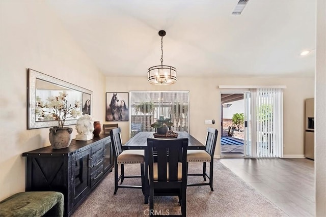 tiled dining area with baseboards, visible vents, and an inviting chandelier