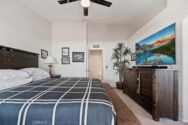 carpeted bedroom with visible vents and a ceiling fan