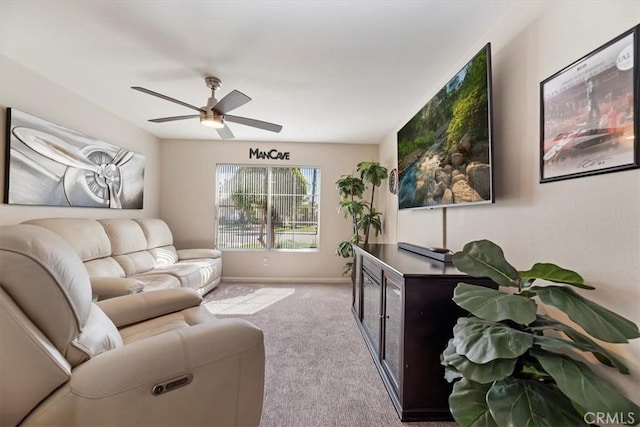 living room with a ceiling fan, carpet flooring, and baseboards