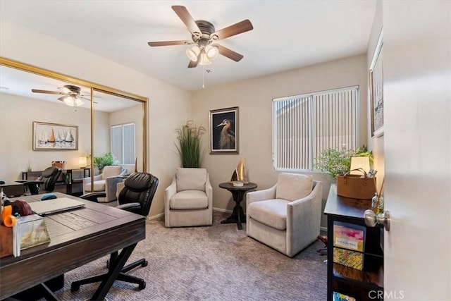 home office with carpet floors, a ceiling fan, and baseboards