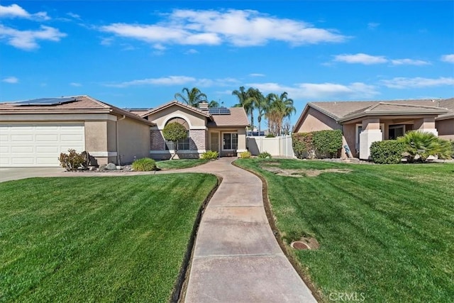 ranch-style house with solar panels, fence, a front lawn, and stucco siding