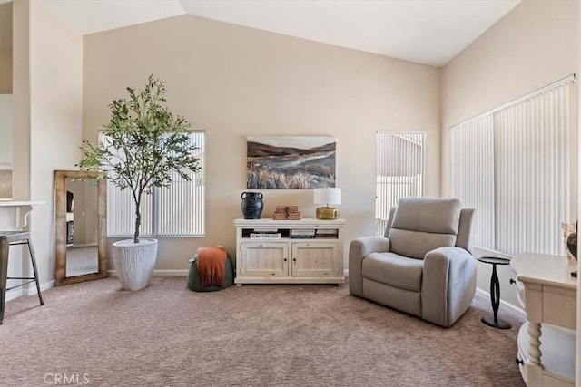 sitting room featuring carpet floors, high vaulted ceiling, and baseboards