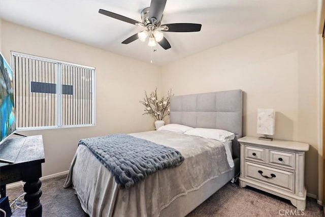 carpeted bedroom with ceiling fan and baseboards