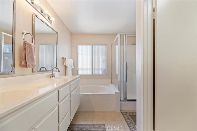 bathroom featuring double vanity, a stall shower, tile patterned floors, a sink, and a bath