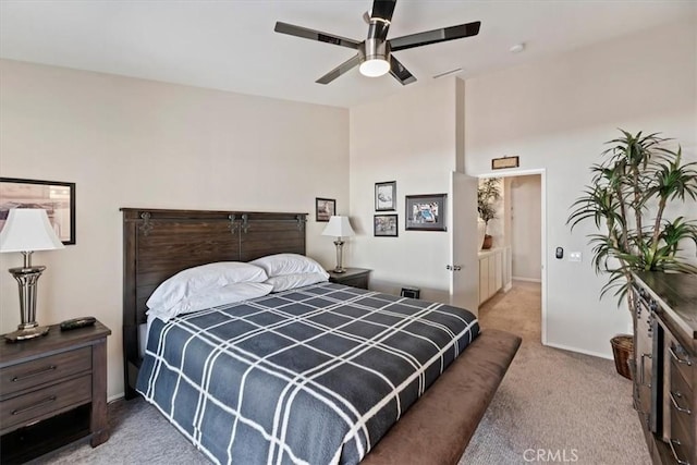 carpeted bedroom with a ceiling fan and baseboards